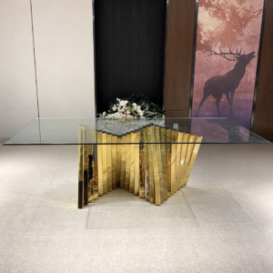 Glass top dining table with gold fold sculpture legs from Xingchen Furniture