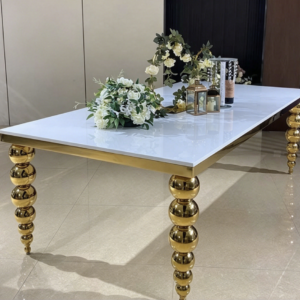 White top gold spindle leg dining table with floral centerpiece for wedding decor