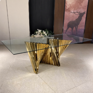Glass top dining table with gold fold sculpture legs from Xingchen Furniture