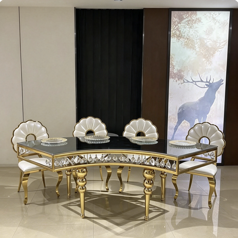 Black curved table with gold crystal legs and shell chairs