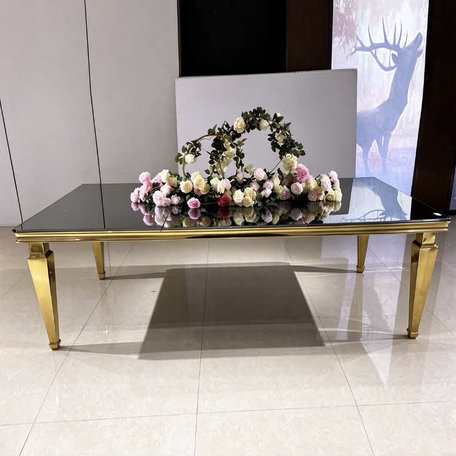 Black glass top gold tapered stainless steel event dining table