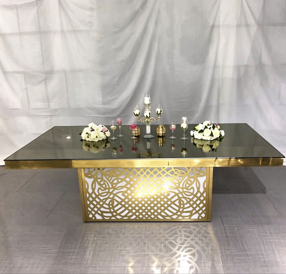 Mirror top wedding banquet table with ornate gold lattice base from Xingchen Furniture