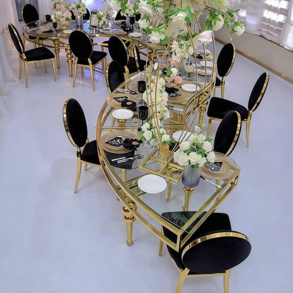 Black curved table with gold crystal legs and shell chairs