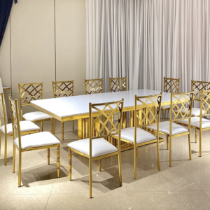 White top gold column leg dining table with cross back chairs from Xingchen Furniture
