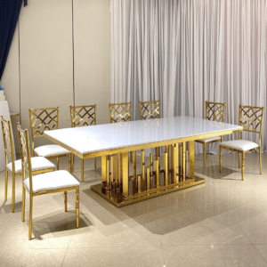 White top gold column leg dining table with cross back chairs from Xingchen Furniture